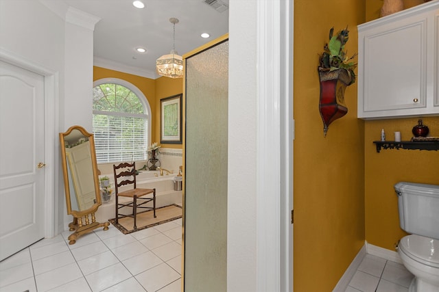 bathroom with tile patterned floors, a washtub, toilet, and ornamental molding