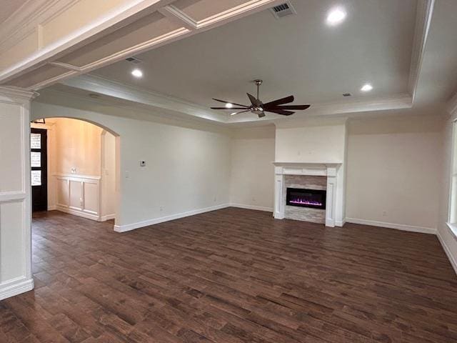 unfurnished living room featuring a raised ceiling, visible vents, a ceiling fan, and dark wood-style flooring
