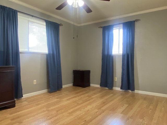  - unfurnished room featuring light wood finished floors, ceiling fan, ornamental molding, and baseboards
