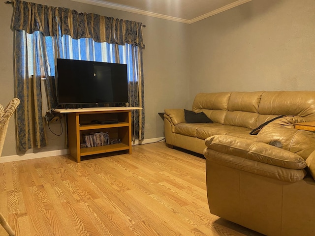  - living area with wood finished floors, ornamental molding, and baseboards