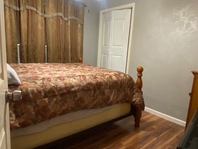  - bedroom featuring dark wood-type flooring and baseboards