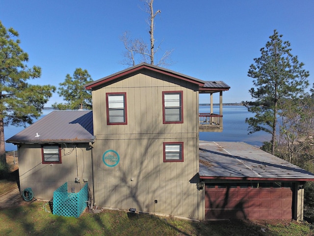 view of home's exterior with a water view