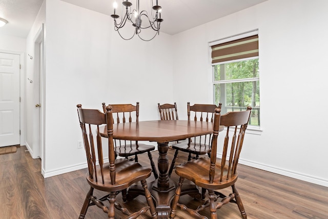 7714 N Linscomb Rd, Vidor, TX 77662 - dining space featuring baseboards, dark wood-style flooring, and a chandelier