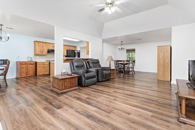 7714 N Linscomb Rd, Vidor, TX 77662 - living room with high vaulted ceiling, ceiling fan with notable chandelier, wood finished floors, and visible vents