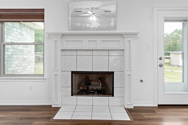 7714 N Linscomb Rd, Vidor, TX 77662 - interior details with a ceiling fan, baseboards, a tiled fireplace, and wood finished floors