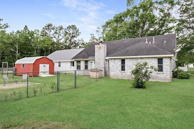 7714 N Linscomb Rd, Vidor, TX 77662 - rear view of house with a lawn, a gate, fence, and a storage shed