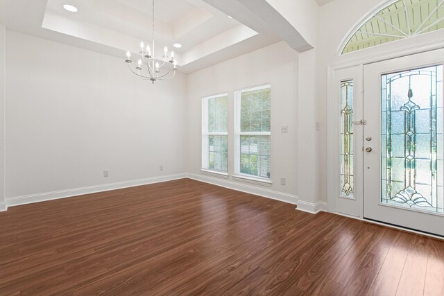 8010 Village Dr, Beaumont, TX 77713 - entryway featuring dark wood-type flooring, a chandelier, a tray ceiling, and baseboards