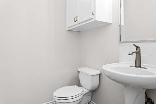 8010 Village Dr, Beaumont, TX 77713 - half bath with baseboards, toilet, and a sink