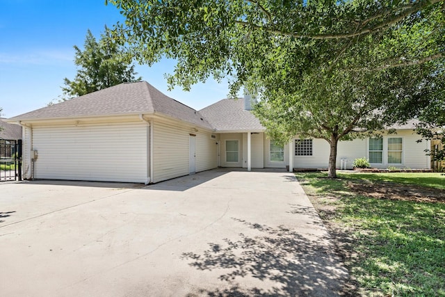 8010 Village Dr, Beaumont, TX 77713 - view of front of house with roof with shingles and a patio area