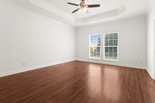 8010 Village Dr, Beaumont, TX 77713 - unfurnished room with dark wood-style floors, a raised ceiling, ceiling fan, crown molding, and baseboards