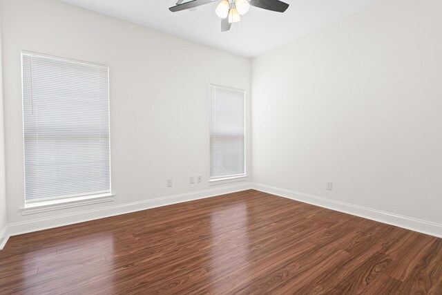 8010 Village Dr, Beaumont, TX 77713 - unfurnished room featuring ceiling fan, dark wood-style floors, and baseboards