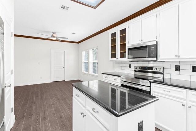 8010 Village Dr, Beaumont, TX 77713 - kitchen featuring stainless steel appliances, ornamental molding, a ceiling fan, baseboards, and glass insert cabinets