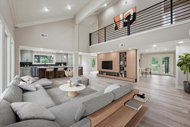 102 Timbercreek Dr, Lumberton, TX 77657 - living area with decorative columns, high vaulted ceiling, ornamental molding, light wood-style flooring, and recessed lighting
