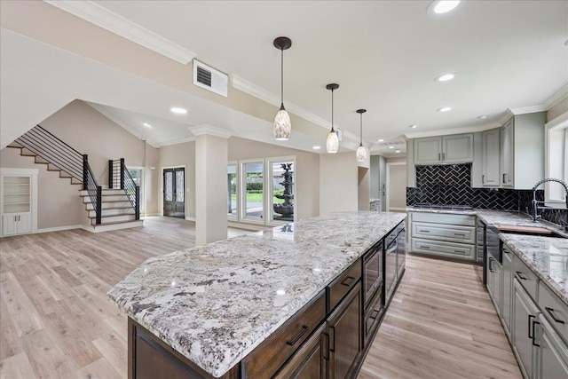 102 Timbercreek Dr, Lumberton, TX 77657 - kitchen featuring decorative backsplash, a center island, recessed lighting, light wood-type flooring, and stovetop