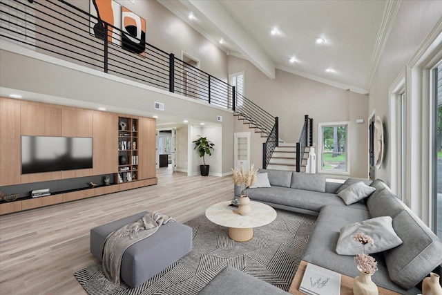 102 Timbercreek Dr, Lumberton, TX 77657 - living room featuring light wood finished floors, ornamental molding, stairs, recessed lighting, and high vaulted ceiling