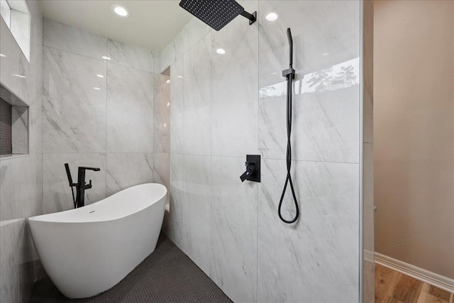 102 Timbercreek Dr, Lumberton, TX 77657 - bathroom featuring tiled shower, a soaking tub, wood finished floors, and tile walls