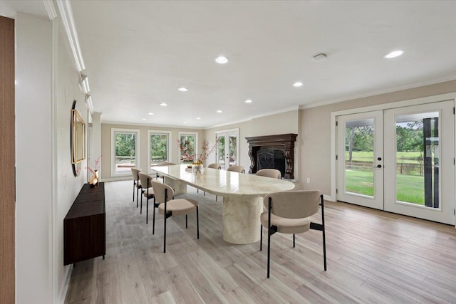 102 Timbercreek Dr, Lumberton, TX 77657 - dining space with healthy amount of natural light, ornamental molding, light wood-style flooring, french doors, and recessed lighting
