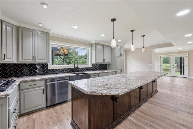 102 Timbercreek Dr, Lumberton, TX 77657 - kitchen featuring stainless steel dishwasher, tasteful backsplash, light wood-style flooring, a center island, and plenty of natural light
