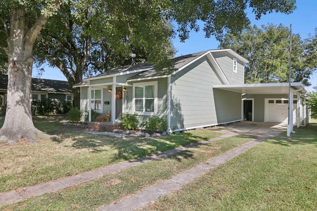 bungalow-style home with a carport, a front lawn, and driveway