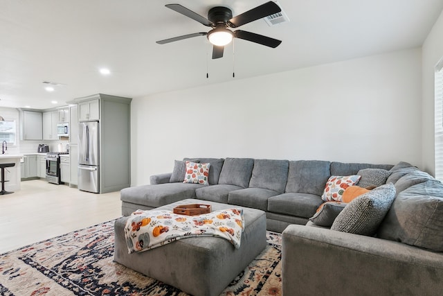 living area with light wood-style flooring, recessed lighting, visible vents, and a ceiling fan