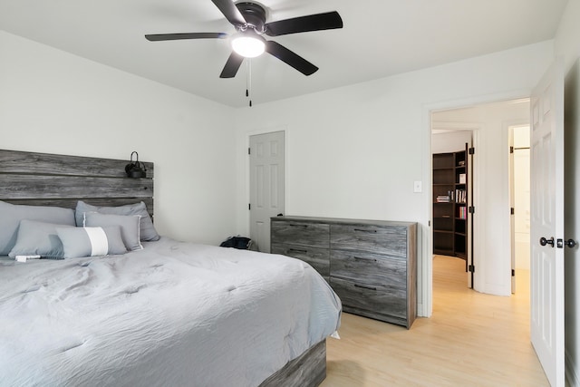 bedroom with ceiling fan and light wood-style flooring