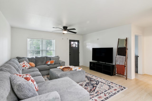 living room with light wood-style flooring and a ceiling fan