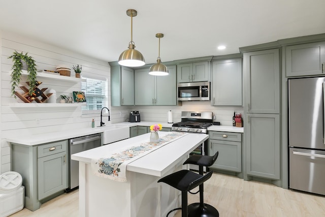 kitchen with open shelves, stainless steel appliances, light countertops, decorative backsplash, and a sink