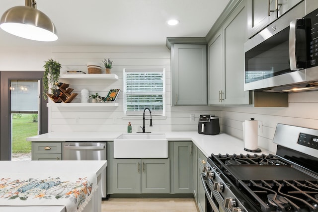 kitchen featuring a sink, stainless steel appliances, light countertops, open shelves, and backsplash