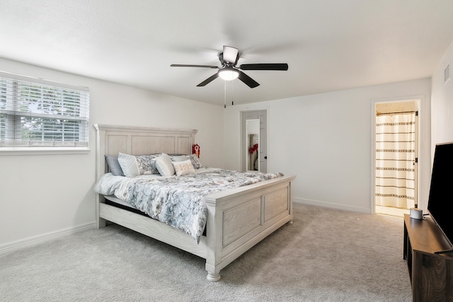 bedroom with light carpet, ceiling fan, and baseboards