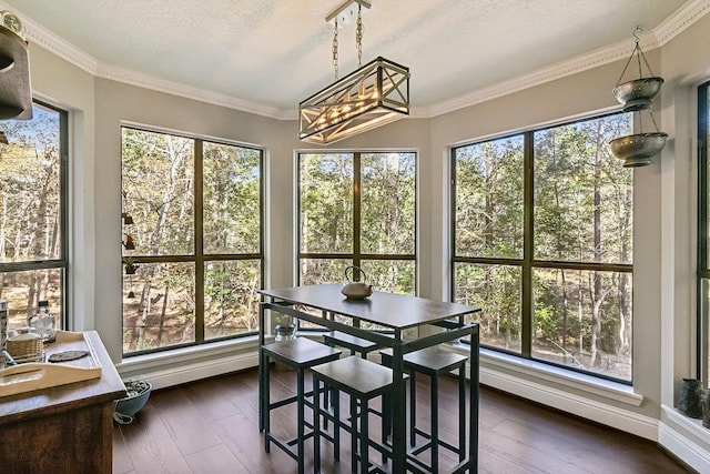 sunroom / solarium featuring an inviting chandelier
