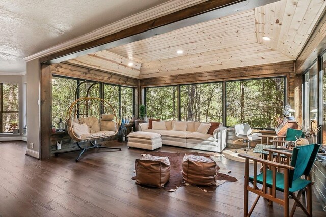 sunroom with wood-type flooring, wooden ceiling, ornamental molding, and lofted ceiling