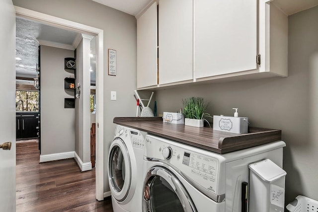 laundry area featuring crown molding, dark wood-style flooring, baseboards, separate washer and dryer, and cabinet space