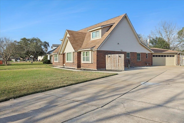 view of side of property with driveway, a garage, a shingled roof, a yard, and brick siding