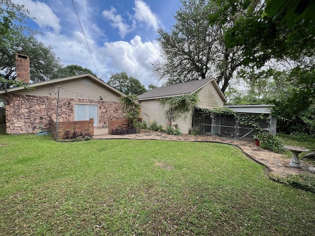 view of front facade with a front lawn, fence, and a chimney