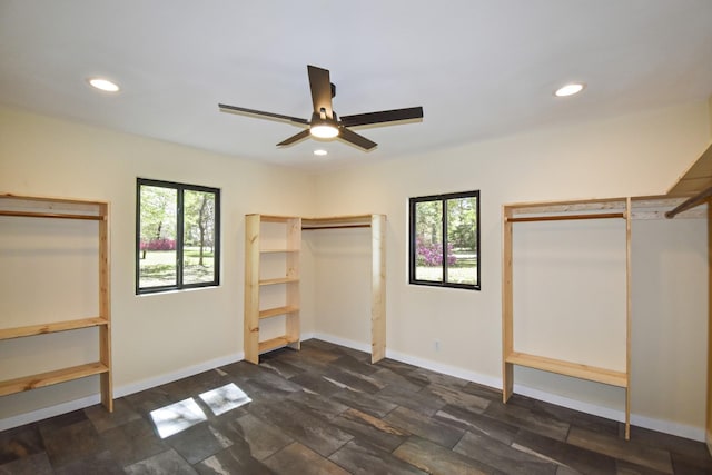 90 Blanton Rd, Lumberton, TX 77657 - unfurnished bedroom with multiple windows, recessed lighting, ceiling fan, and dark stone finish floors