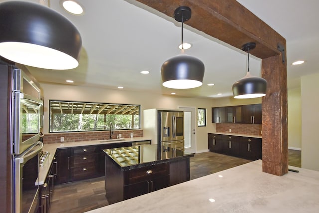 90 Blanton Rd, Lumberton, TX 77657 - kitchen with decorative backsplash, plenty of natural light, dark brown cabinetry, and recessed lighting