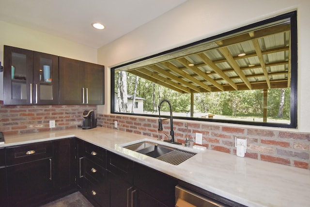 90 Blanton Rd, Lumberton, TX 77657 - kitchen with light countertops, glass insert cabinets, decorative backsplash, and dark brown cabinets