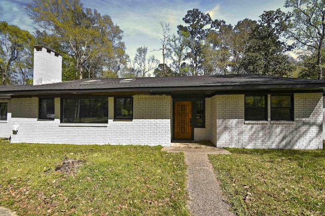 90 Blanton Rd, Lumberton, TX 77657 - view of front of home featuring brick siding, a chimney, and a front yard