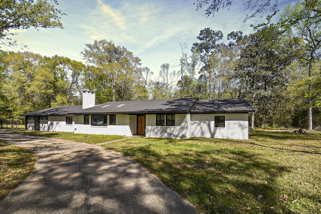 90 Blanton Rd, Lumberton, TX 77657 - view of front facade with brick siding, a front lawn, and a chimney