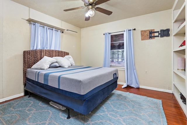 6531 Childress Ln, Kountze, TX 77625 - bedroom with wood finished floors, baseboards, and ceiling fan