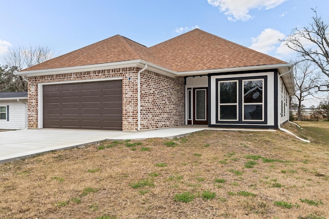 view of front of property with a garage and a front lawn