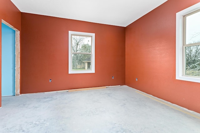 spare room with concrete floors