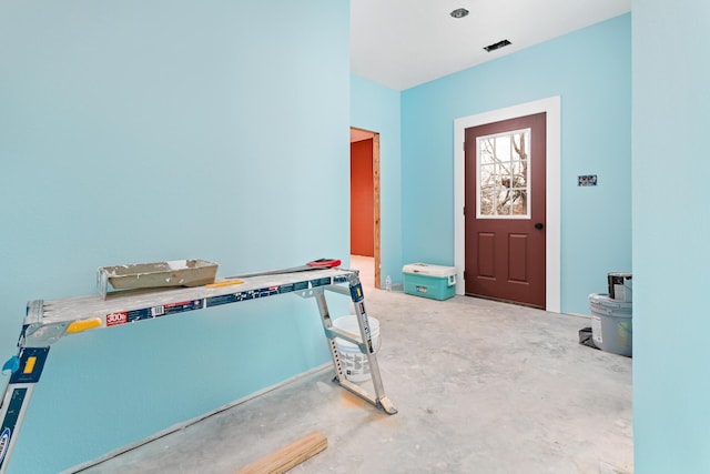 foyer entrance featuring concrete floors