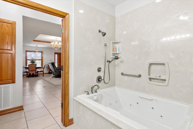 bathroom featuring a notable chandelier, a bathtub, and tile patterned flooring