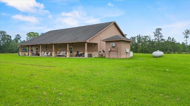 rear view of property with a yard