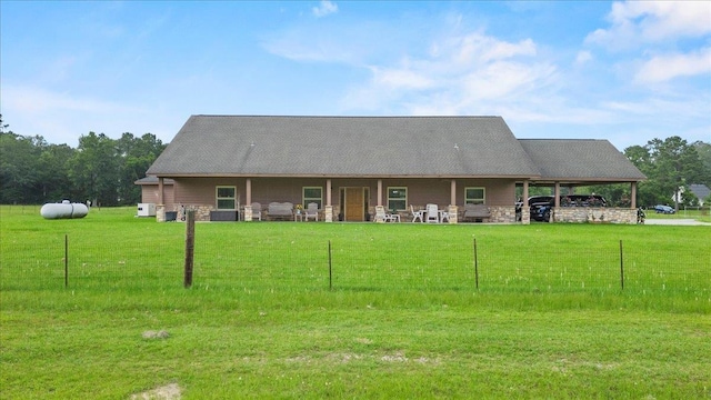 back of property featuring a yard