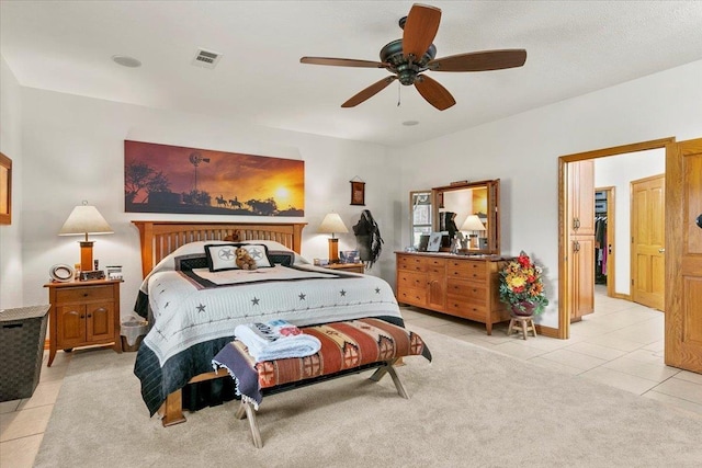 tiled bedroom with ceiling fan