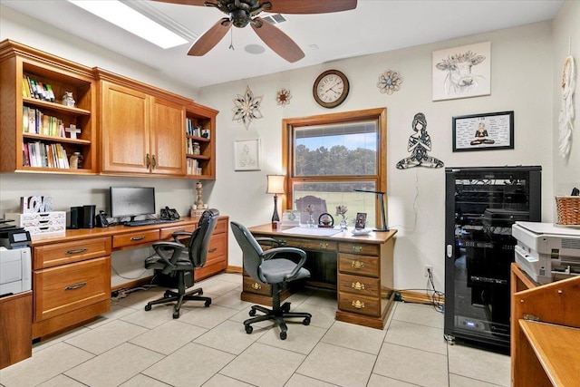 tiled office space with ceiling fan and beverage cooler