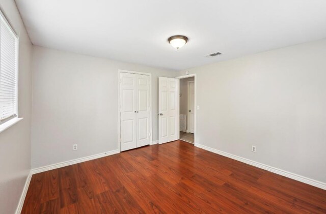 504 David Dr, Bridge City, TX 77611 - unfurnished bedroom featuring wood finished floors, baseboards, and a closet