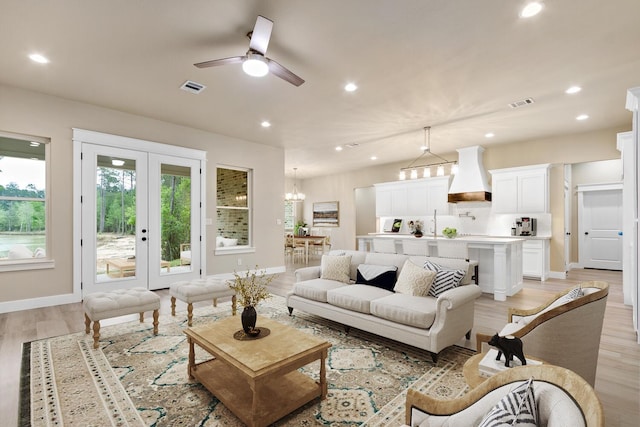 living room featuring light hardwood / wood-style floors and ceiling fan